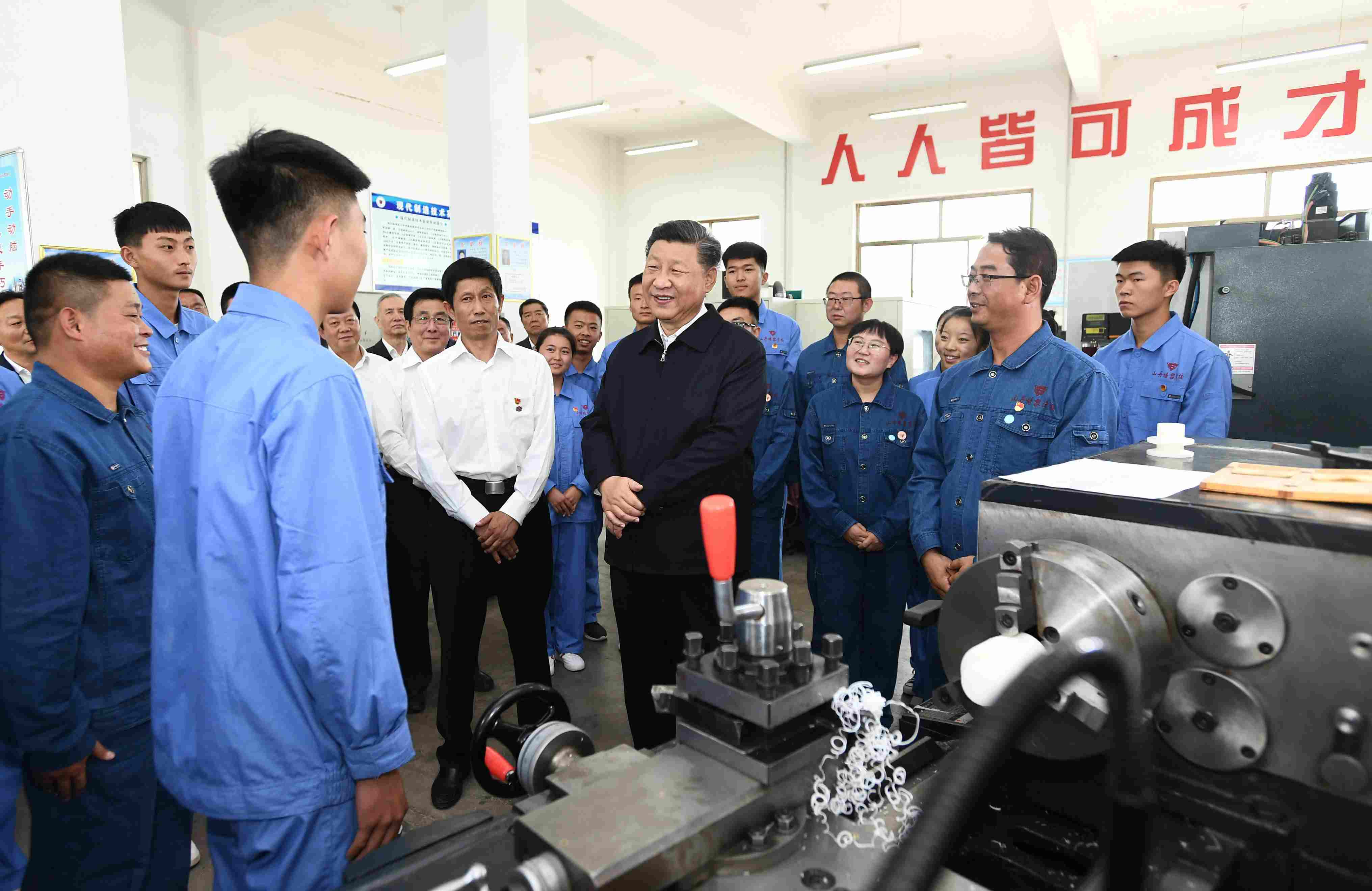 2019年8月20日，習(xí)近平在甘肅省張掖市山丹培黎學(xué)?，F(xiàn)代制造技術(shù)實訓(xùn)室，觀看職業(yè)技能實訓(xùn)，同師生親切交流。
