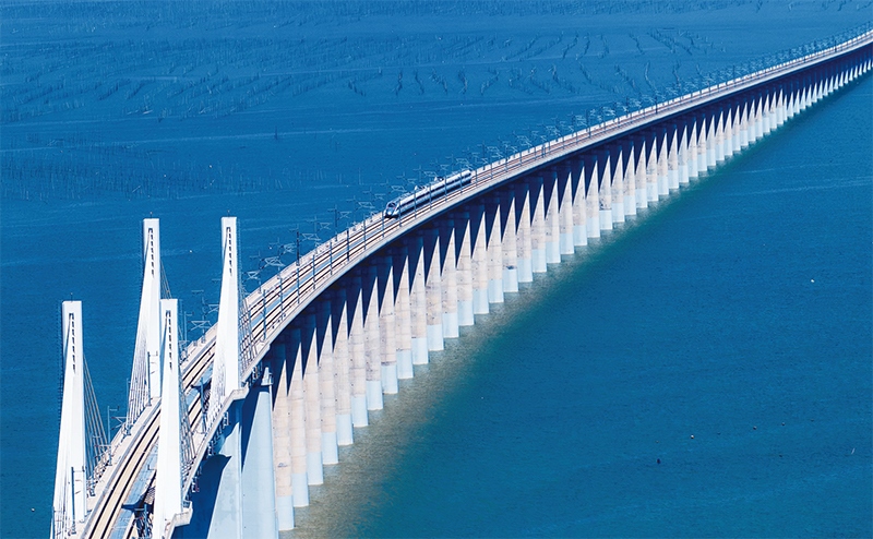 2023年9月28日，中國首條時速350公里跨海高鐵——福廈高鐵正式開通運營。圖為一列運行試驗車組駛過福廈高鐵湄洲灣跨海大橋（9月19日攝，無人機(jī)照片）。 新華社記者 魏培全/攝