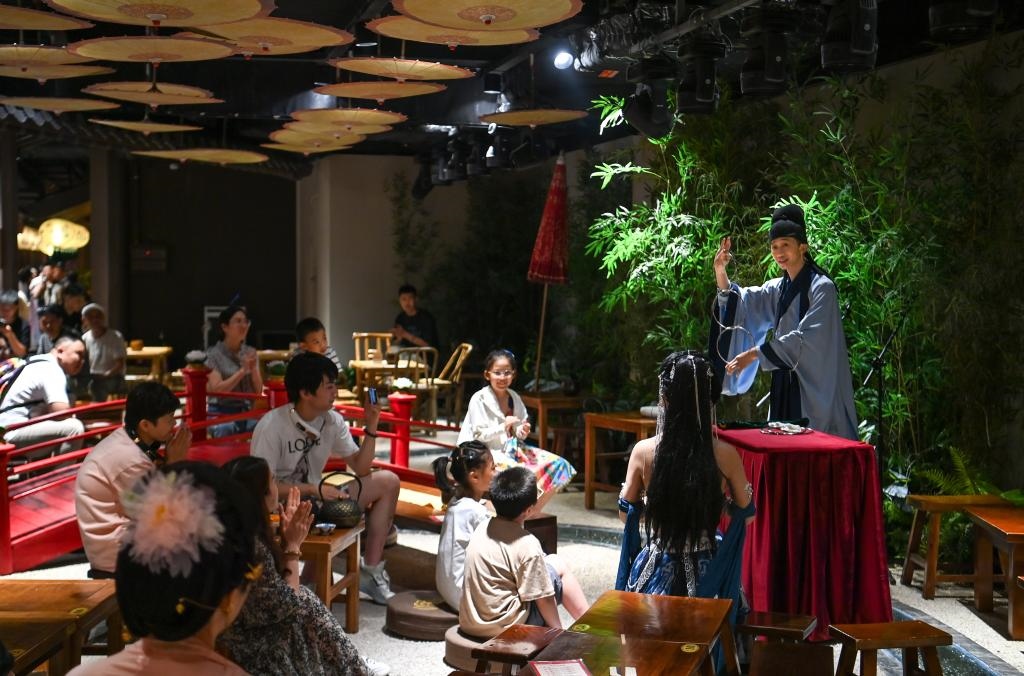 游客在長安十二時辰主題街區(qū)觀看唐風(fēng)演藝《大唐曲藝》。新華社記者鄒競一 攝