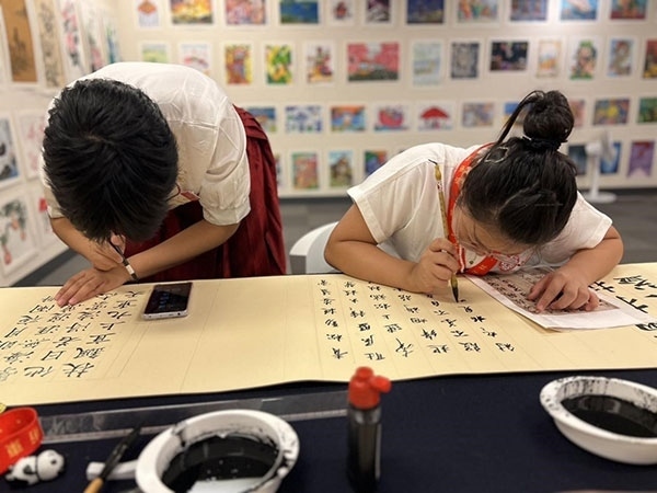 參加本次展覽的青少年在現場進行書法創(chuàng)作。主辦方供圖