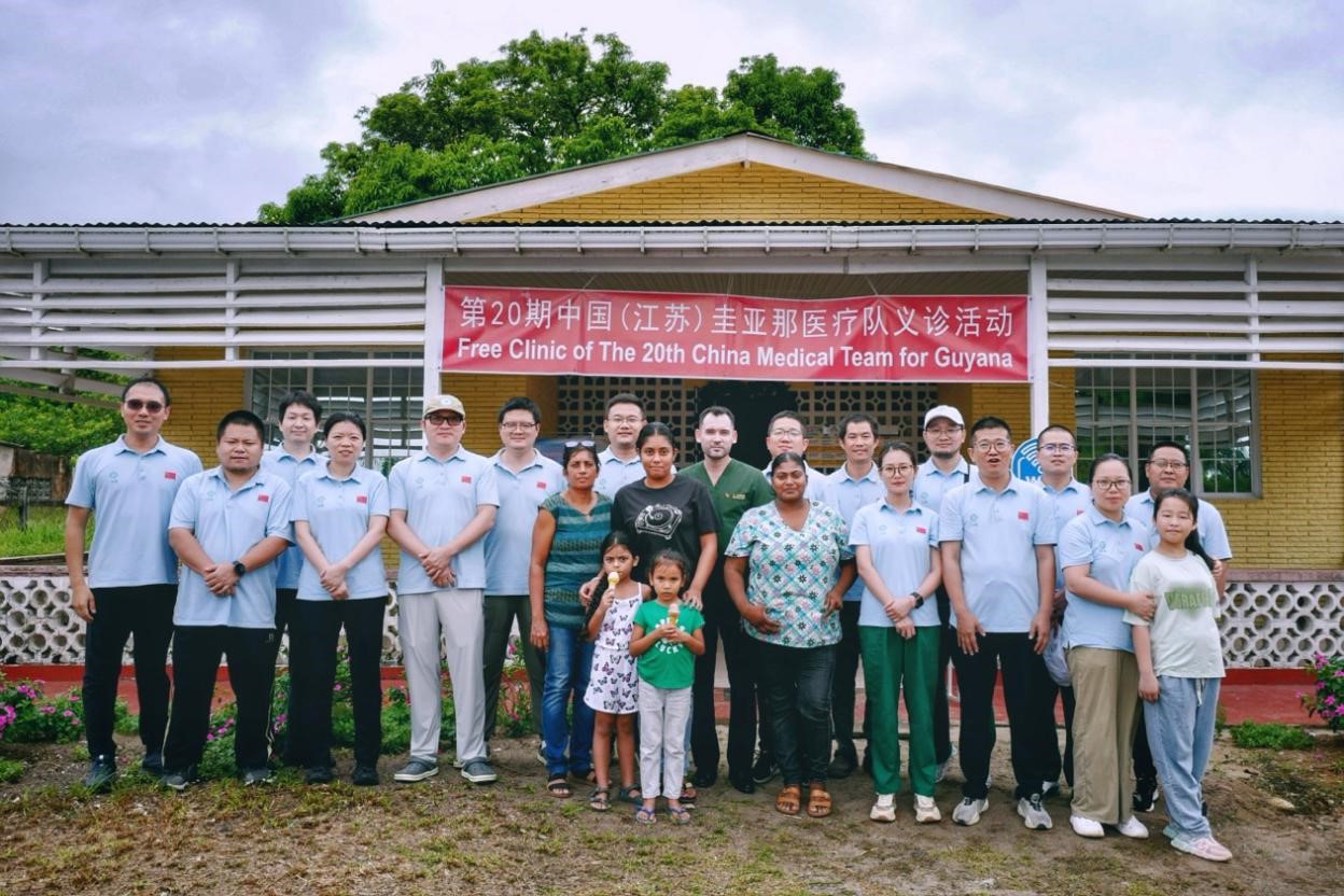 第20期中國（江蘇）援圭亞那醫(yī)療隊在圭偏遠的林登高速社區(qū)開展義診后，與部分當地居民合影。 中國援圭醫(yī)療隊供圖