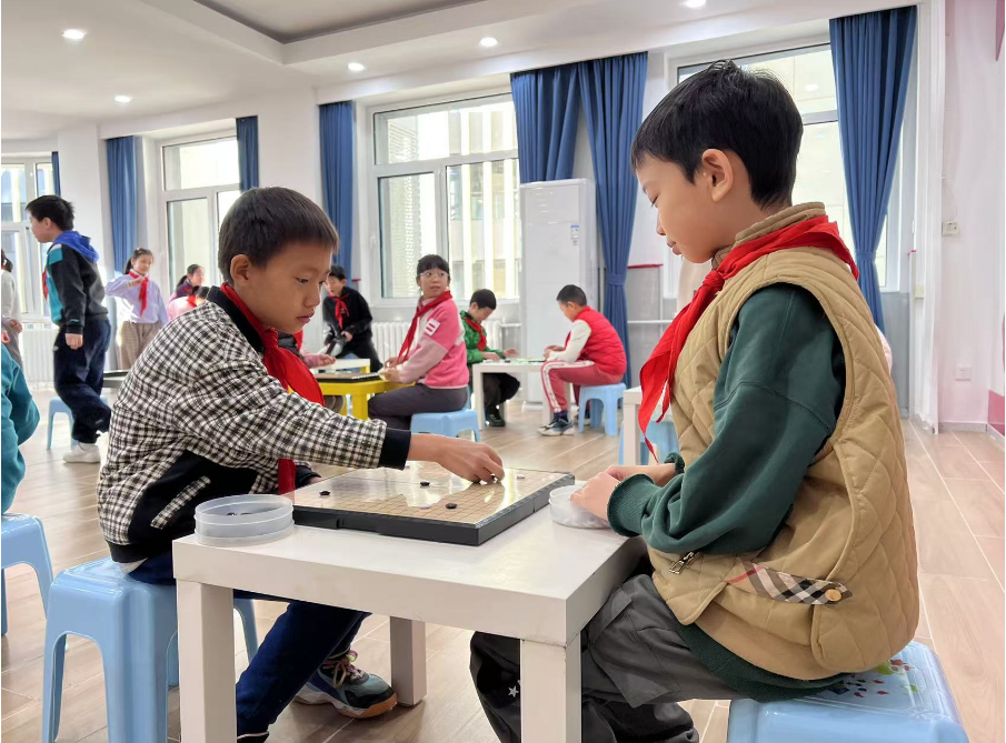學(xué)生們?cè)谏傧汝?duì)大廳下圍棋。人民網(wǎng) 白炅攝