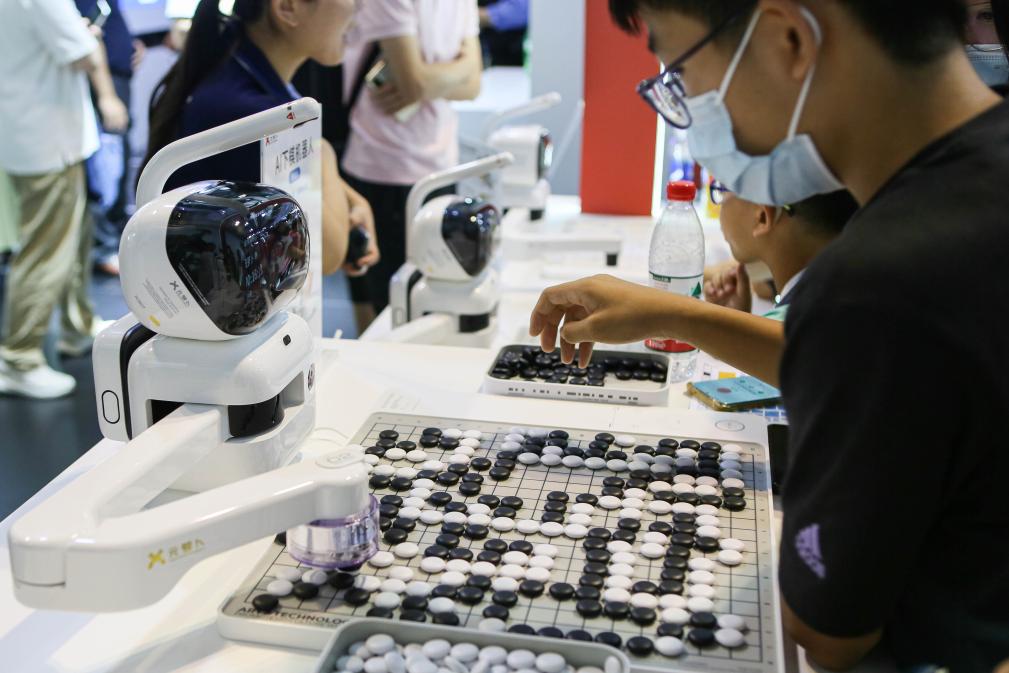 2023年7月7日，元蘿卜AI下棋機器人與觀眾對弈。2023年7月6日至8日，2023世界人工智能大會在上海舉行。新華社記者 辛夢晨 攝